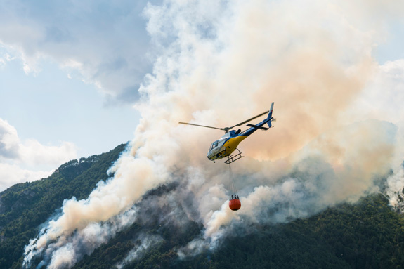 Fighting fires is one of the top helicopter pilot jobs available after completing your helicopter training